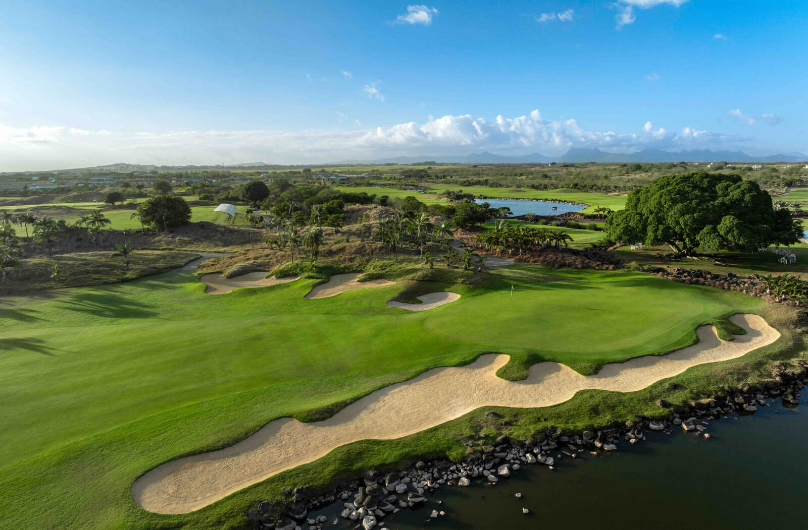 Sweeping bunkers along a coastal fairway in Mauritius